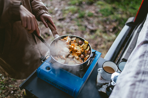 Person cooking at a campsite